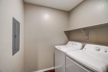 A small laundry room with a washer and dryer.